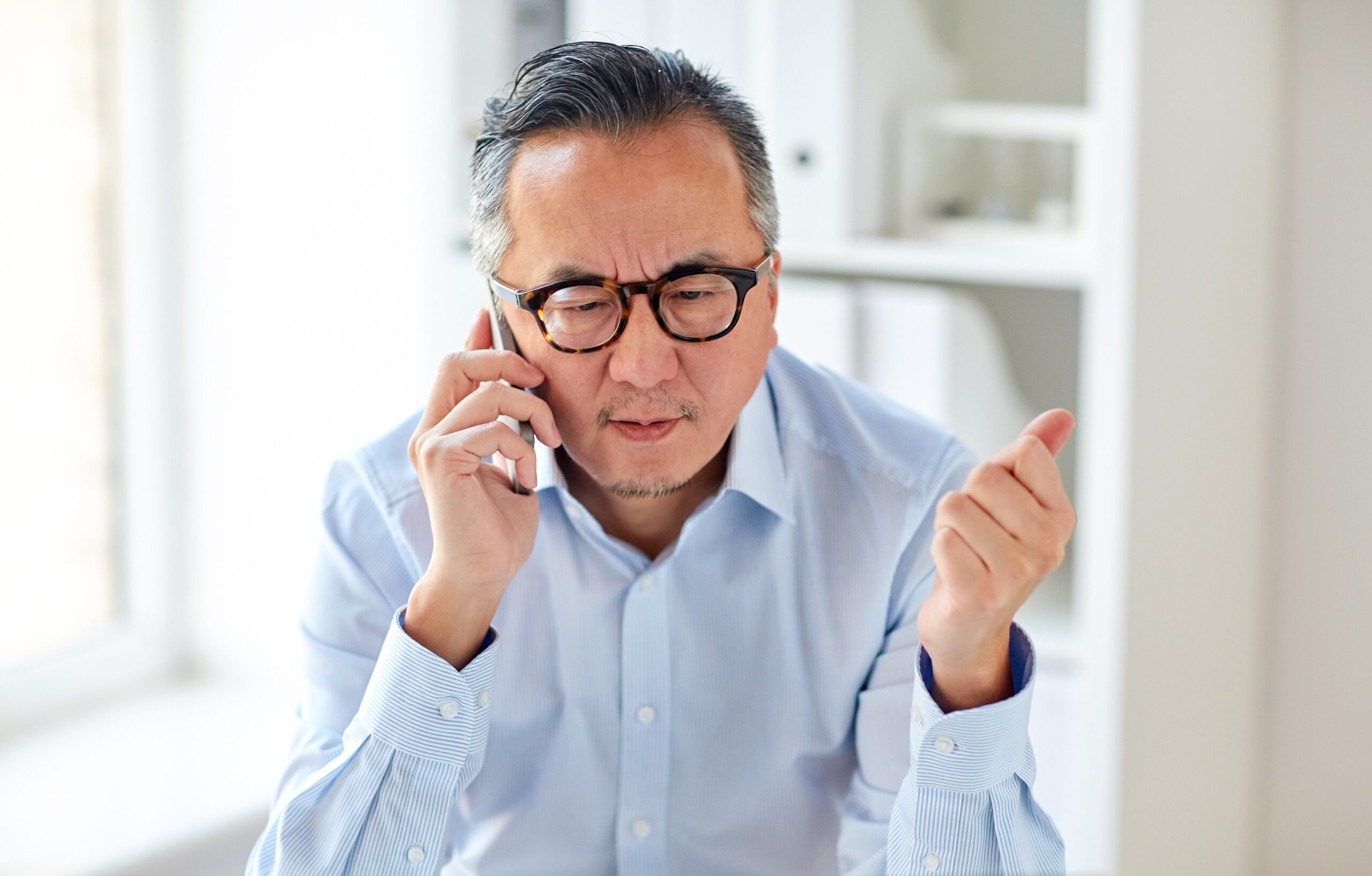 Man on phone calling about a claim to report.