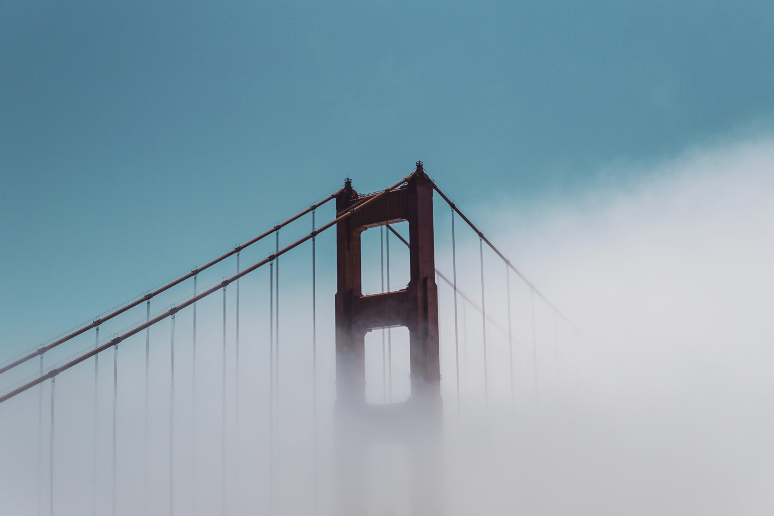 Golden Gate Bridge covered by fog.