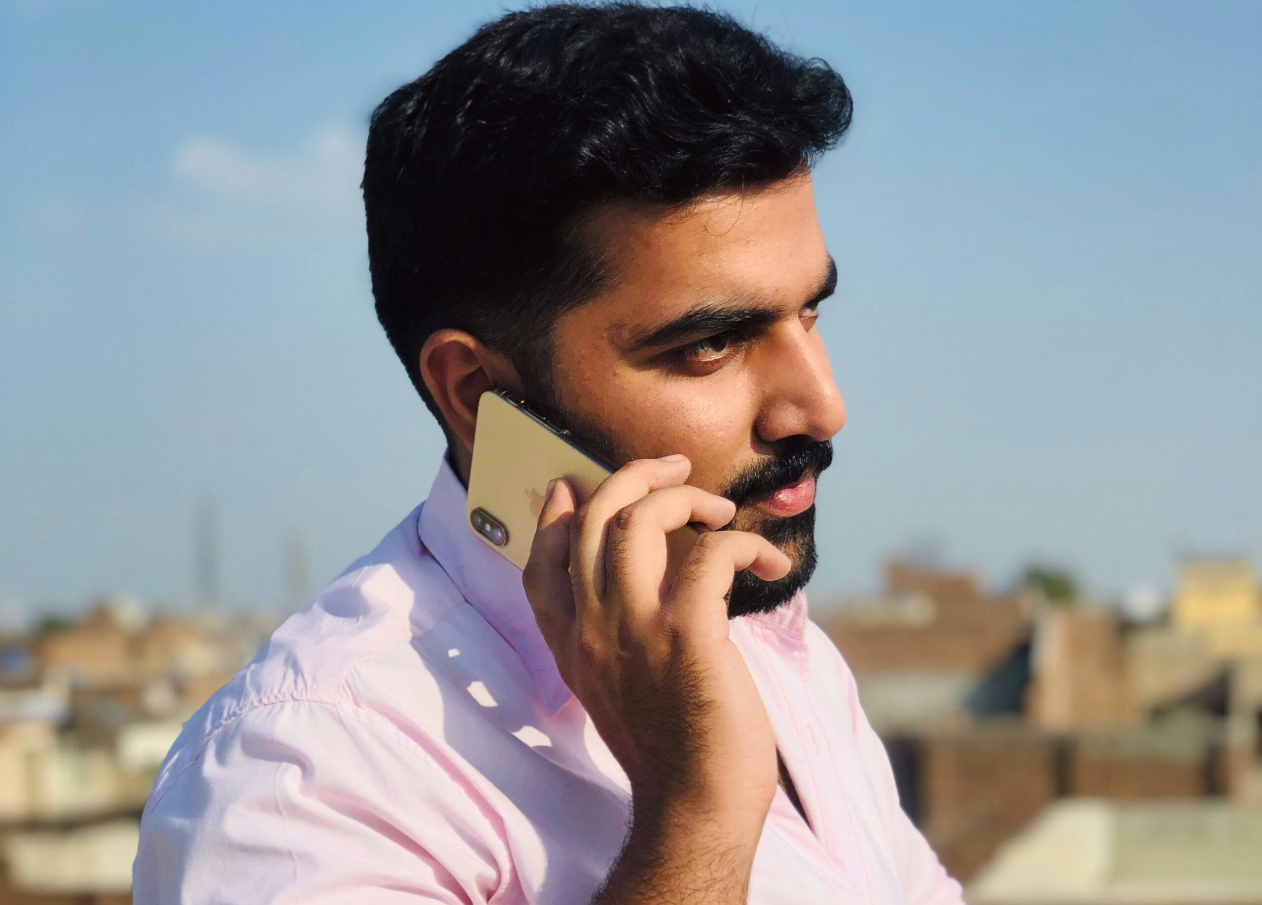 Man using cellphone to call insurance company.
